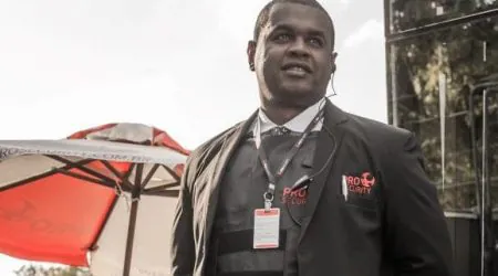 Profissional de Segurança fardado na lateral de um edifício comercial